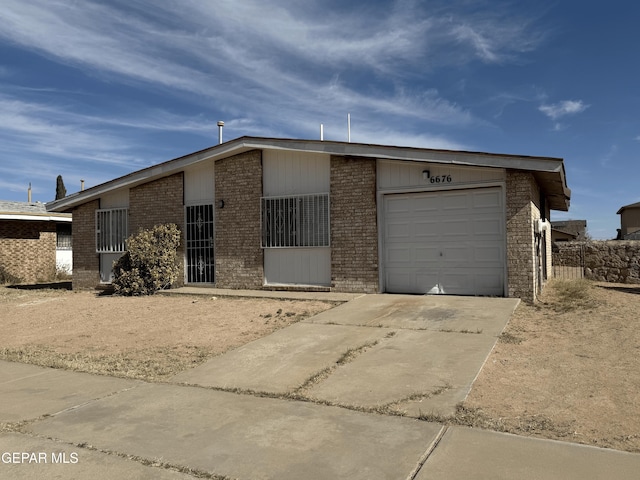 view of front of house with a garage, concrete driveway, and brick siding