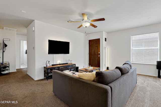 carpeted living room with a ceiling fan, visible vents, and baseboards