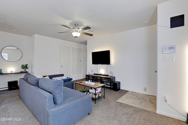 carpeted living room with ceiling fan, visible vents, and baseboards