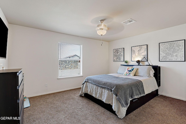 carpeted bedroom with baseboards, visible vents, and a ceiling fan