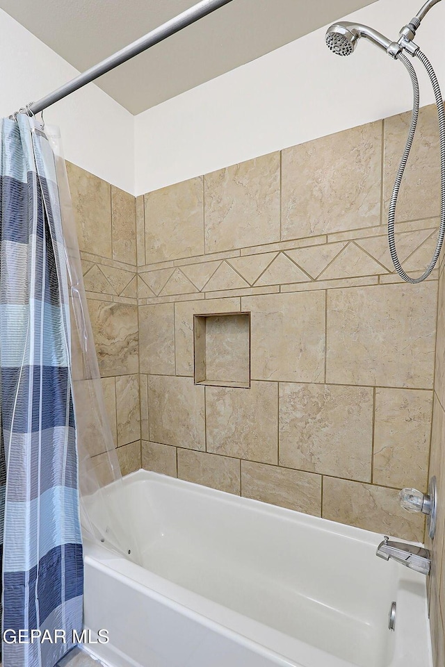 bathroom with shower / bath combination with curtain