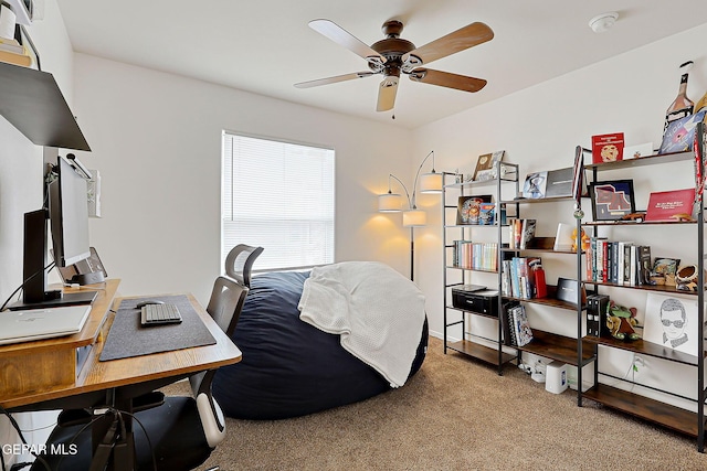 carpeted office featuring a ceiling fan