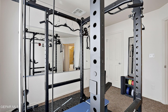 workout area with baseboards, visible vents, and carpet flooring