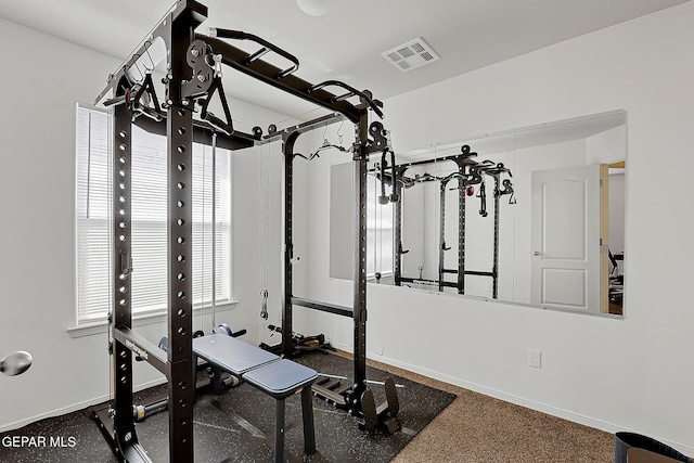 exercise room featuring baseboards and visible vents