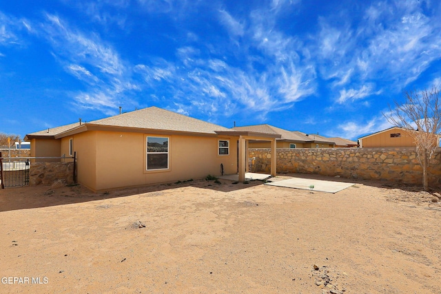 back of property featuring a patio area, fence, and stucco siding