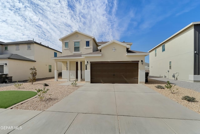 traditional home with concrete driveway and stucco siding