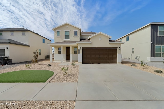 view of front of house with a garage, driveway, and stucco siding