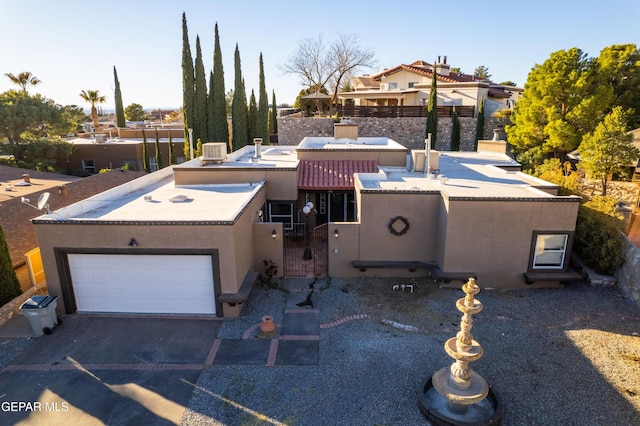 view of front of home with central air condition unit, fence, driveway, a gate, and stucco siding