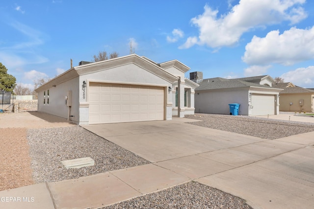 single story home featuring concrete driveway, an attached garage, fence, and stucco siding