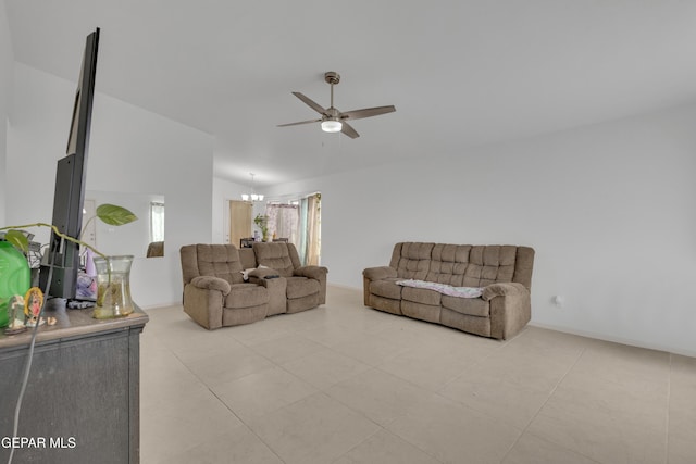 living area with vaulted ceiling, light tile patterned floors, ceiling fan with notable chandelier, and a wealth of natural light