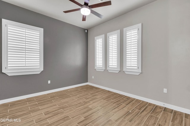 spare room with ceiling fan, baseboards, and wood finish floors