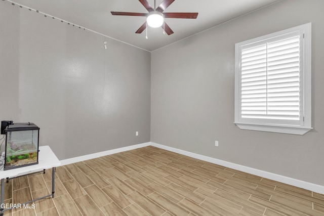 unfurnished room featuring wood finish floors, ceiling fan, and baseboards