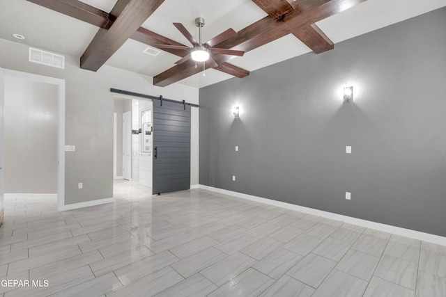 empty room featuring beam ceiling, visible vents, a barn door, ceiling fan, and baseboards