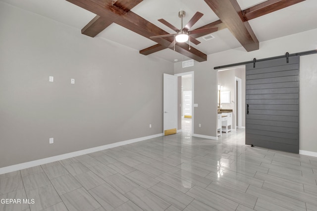 unfurnished room featuring visible vents, a barn door, a ceiling fan, beamed ceiling, and baseboards