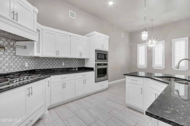 kitchen with custom exhaust hood, stainless steel appliances, visible vents, decorative backsplash, and a sink