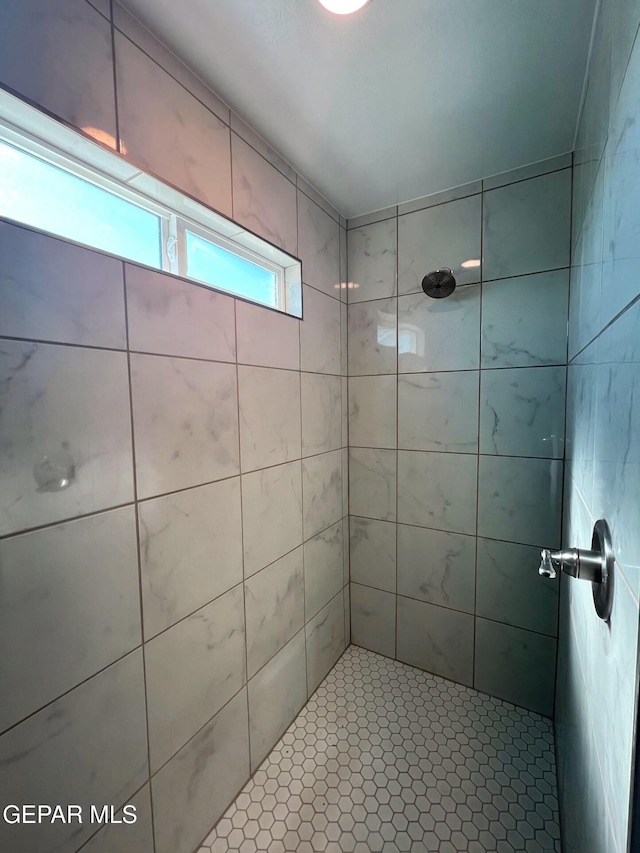 bathroom with a tile shower