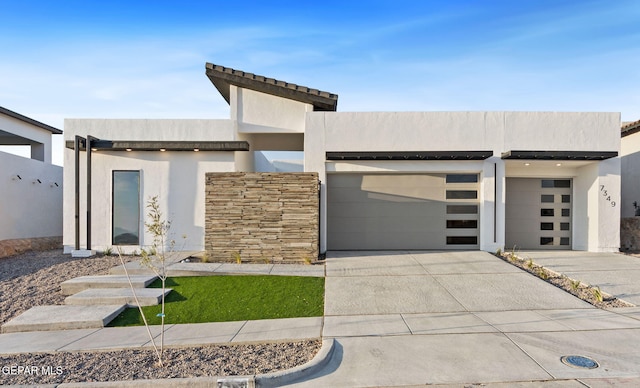 contemporary home with driveway and stucco siding