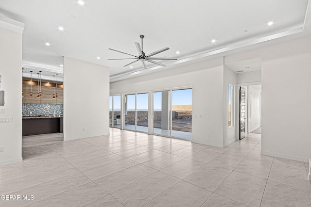 unfurnished living room featuring a ceiling fan, recessed lighting, and baseboards