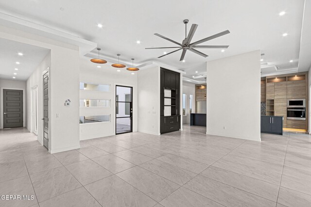 unfurnished living room with a ceiling fan, recessed lighting, and baseboards