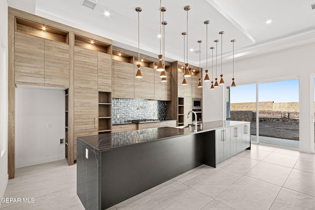 kitchen featuring visible vents, stainless steel gas stovetop, open shelves, and modern cabinets