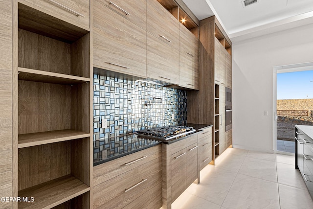 kitchen featuring modern cabinets, appliances with stainless steel finishes, open shelves, and decorative backsplash