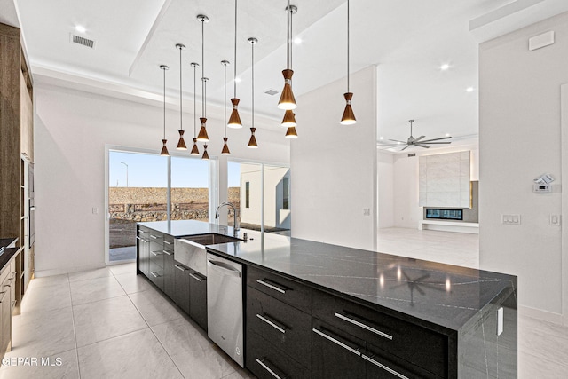 kitchen with visible vents, stainless steel dishwasher, a sink, modern cabinets, and dark cabinets