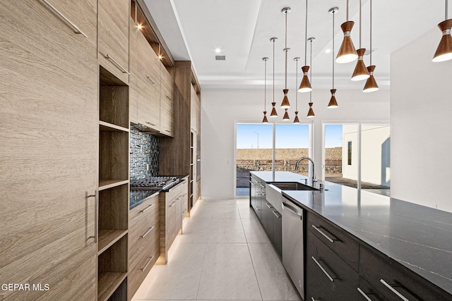 kitchen featuring stainless steel appliances, modern cabinets, a sink, and decorative backsplash