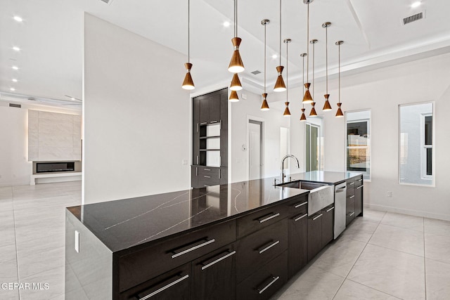 kitchen featuring light tile patterned floors, visible vents, modern cabinets, a tray ceiling, and a sink