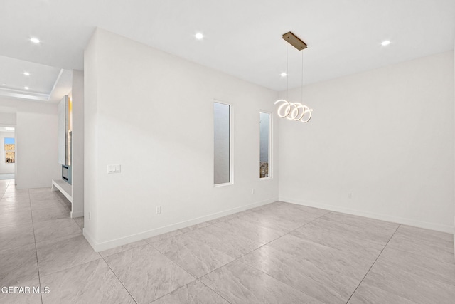 unfurnished room with recessed lighting and baseboards