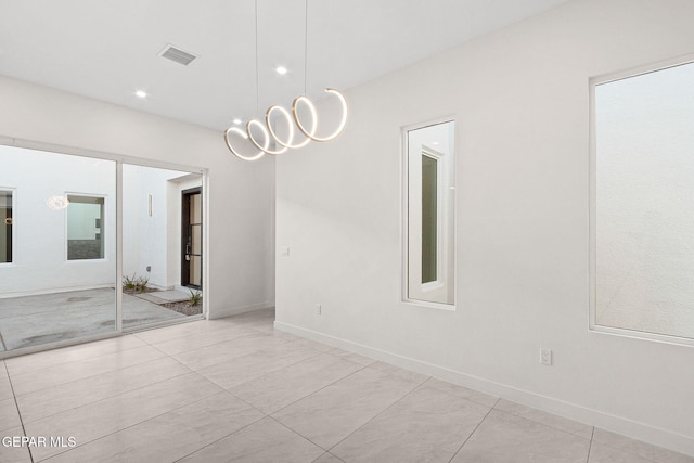 spare room featuring baseboards, visible vents, and recessed lighting