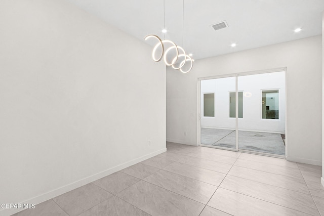 empty room featuring light tile patterned floors, baseboards, visible vents, and a chandelier