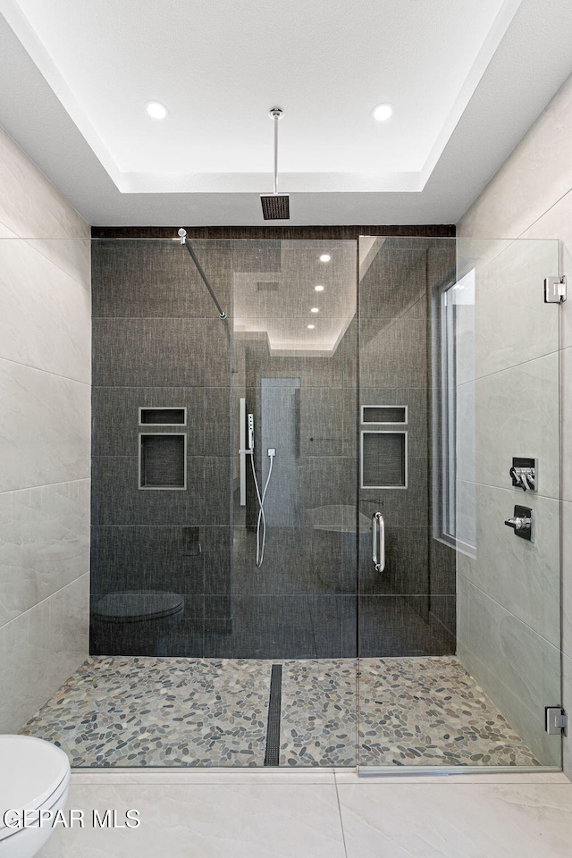 full bath with toilet, a stall shower, and visible vents