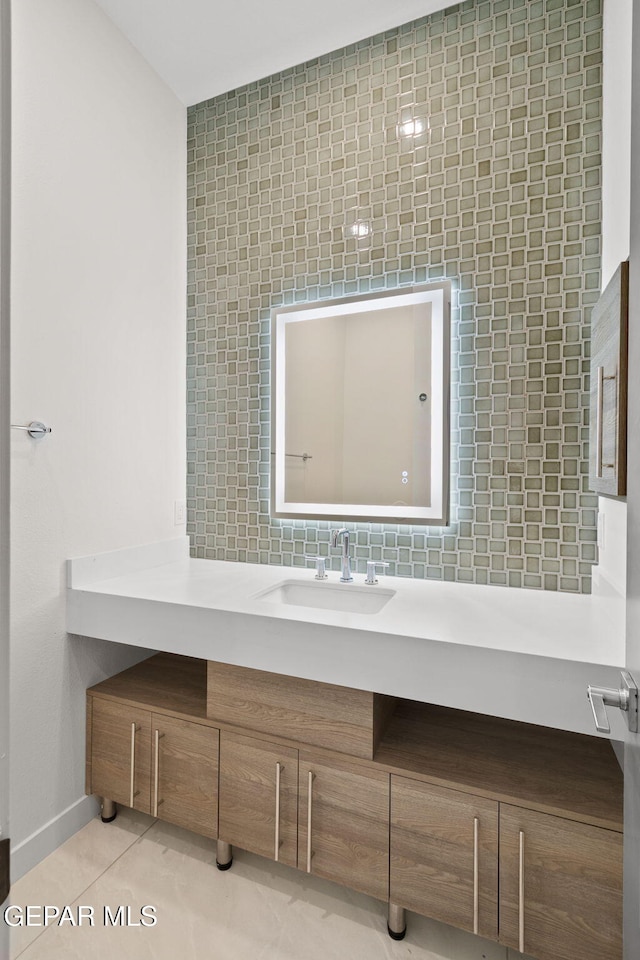 bathroom featuring tasteful backsplash, tile patterned flooring, and vanity