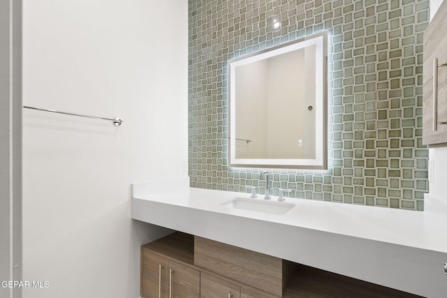 bathroom with vanity and decorative backsplash