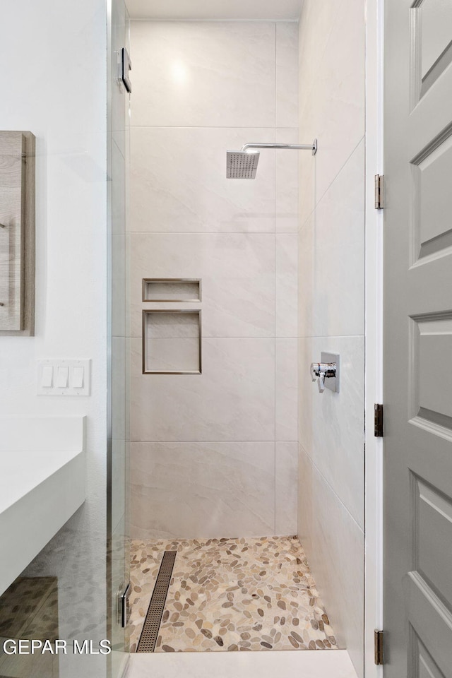 bathroom with a shower stall