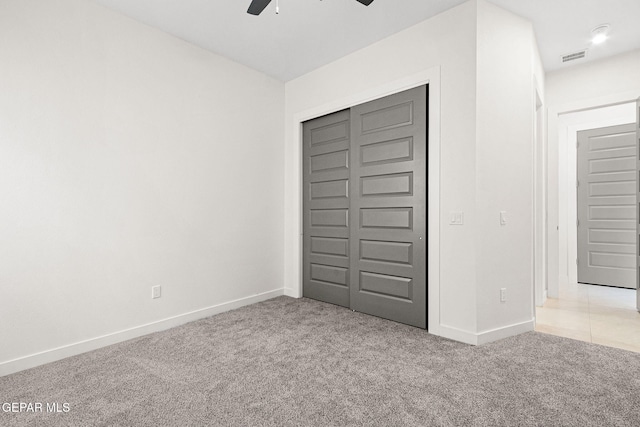 unfurnished bedroom featuring a closet, carpet, and baseboards