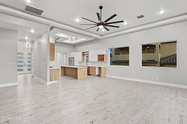 unfurnished living room with visible vents, ceiling fan, and light wood finished floors