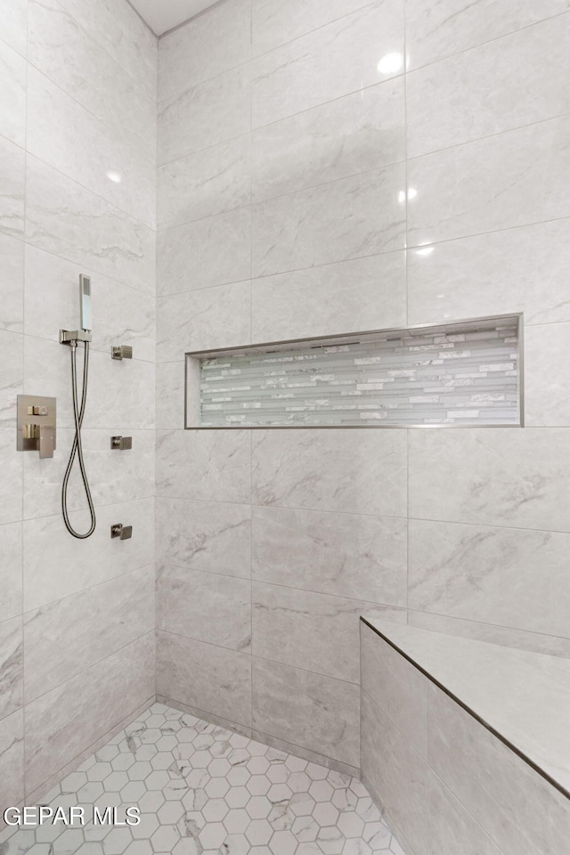 full bath with a tile shower