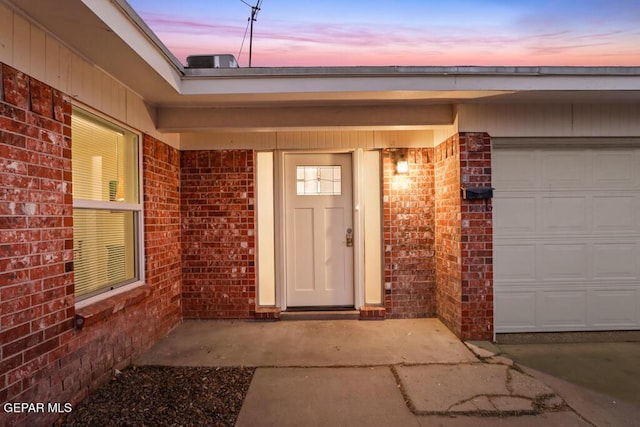 property entrance featuring brick siding