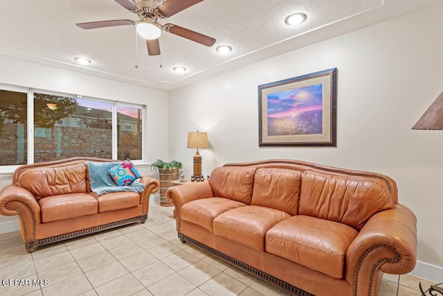 living room with light tile patterned floors, ceiling fan, a textured ceiling, and recessed lighting