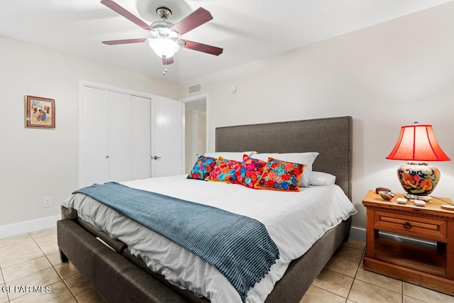 bedroom with a closet, visible vents, baseboards, and light tile patterned floors