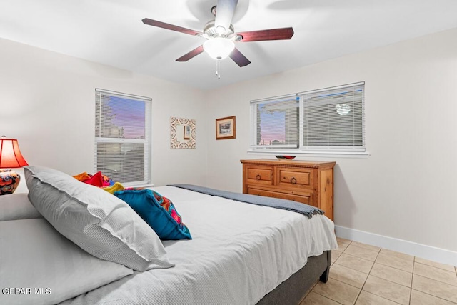 bedroom with light tile patterned floors, ceiling fan, and baseboards