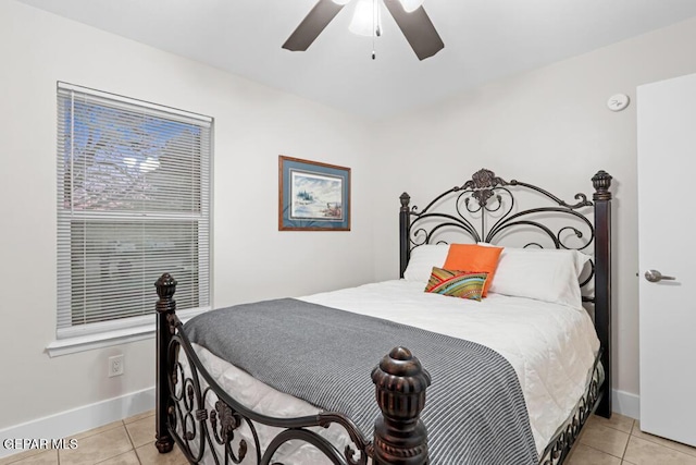 bedroom with ceiling fan, baseboards, and light tile patterned floors