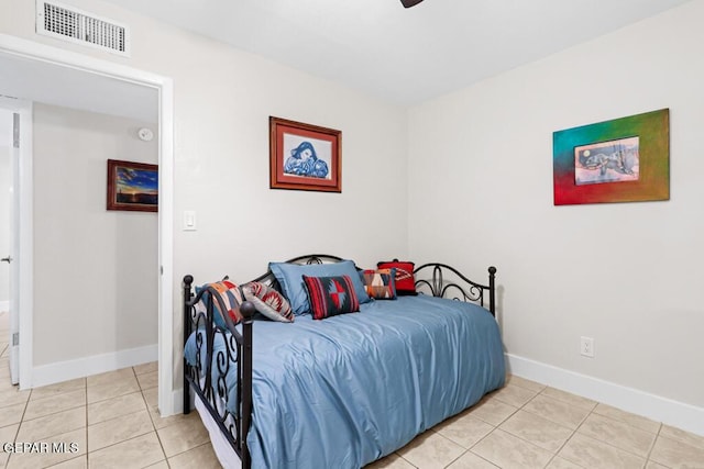 bedroom featuring light tile patterned floors, visible vents, and baseboards