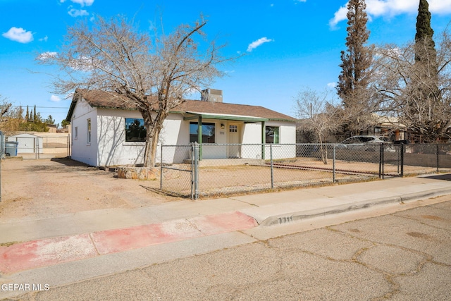 single story home with driveway, a fenced front yard, a chimney, a gate, and stucco siding