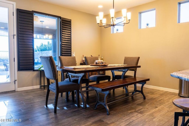 dining room featuring dark wood-type flooring, plenty of natural light, and baseboards