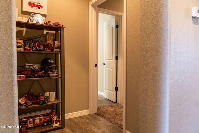 interior space featuring baseboards and wood finished floors