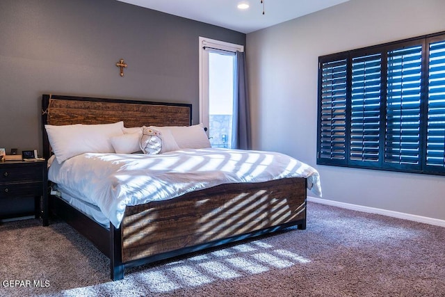 bedroom with carpet flooring and baseboards