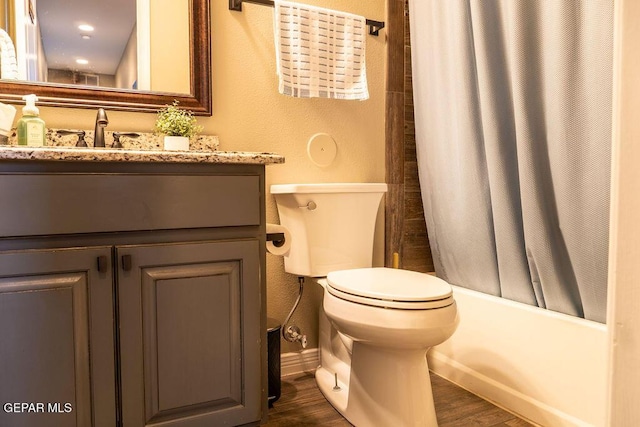 bathroom with shower / bath combination with curtain, vanity, toilet, and wood finished floors