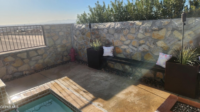 view of patio featuring fence